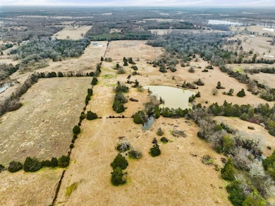 Birds eye view of property with a water view and a