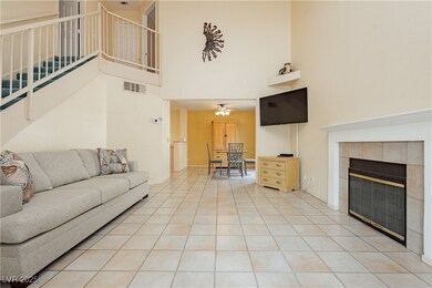 Living room featuring a towering ceiling, stairs,