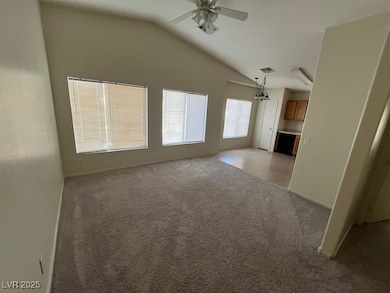 Unfurnished living room with ceiling fan, lofted c