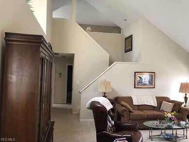 Vaulted ceilings with open stairs to loft area.