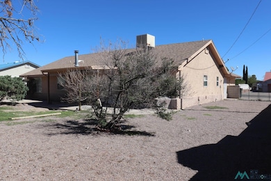 Rear view of house featuring crawl space, roof with shingles, and stucco siding