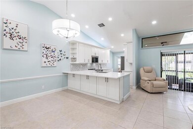 Kitchen featuring lofted ceiling, stainless steel microwave, a peninsula, tasteful backsplash, and open shelves