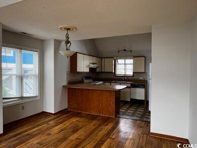 Kitchen with range, kitchen peninsula, dishwasher,