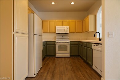 The kitchen cabinets are freshly painted and the c