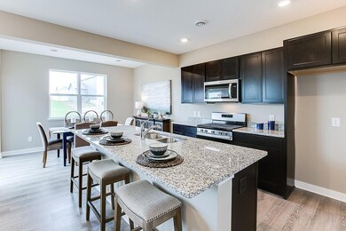 The popular Edmon floor plan, with a shining star of a kitchen! *Model photo, selections and colors may vary!  The acutal home will have white cabinets.