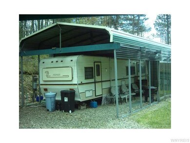 Exterior Front. Hy-Line camper with carport and pa