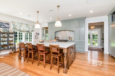 Kitchen featuring pendant lighting, light wood-style floors, a large island, a kitchen bar, and recessed lighting