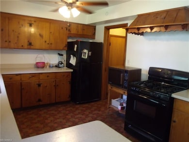 Viewing towards the appliances that will stay, and out that door to the storage closet, garage, and steps to the basement!