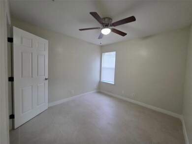 Unfurnished room with a ceiling fan and baseboards