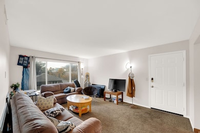 Carpeted living room with baseboards