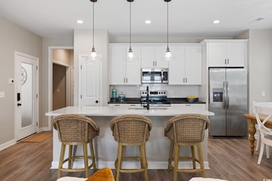 Kitchen with white cabinetry, stainless steel appl