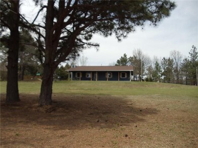 View of house from street. House sits up on hill a