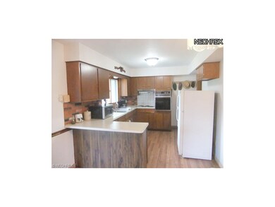 The kitchen also features an open layout with plen