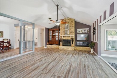 Living room with wood burning fireplace, new lamin