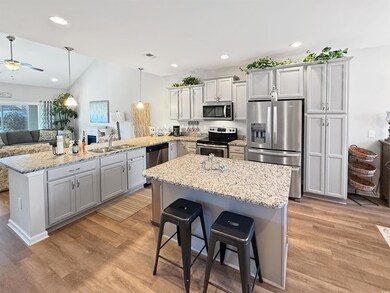 Kitchen with sink, gray cabinetry, decorative ligh