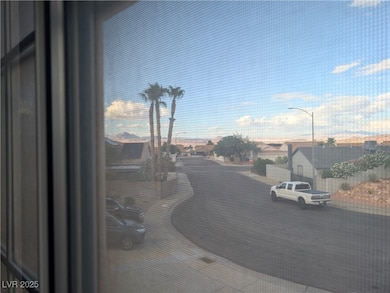 View of asphalt road featuring curbs, sidewalks, and street lights