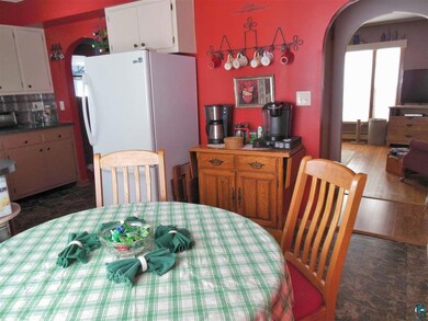 This dining room is open to the kitchen with beaut