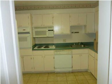 Kitchen with electric cooktop and oven
