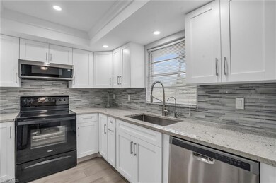 Kitchen with backsplash, appliances with stainless