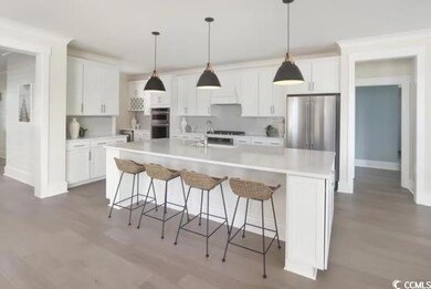 Kitchen with a breakfast bar, a sink, light counte