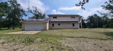Left view of house featuring a garage, solar panel
