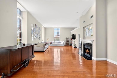 Living area featuring a fireplace with flush hearth and light wood finished floors