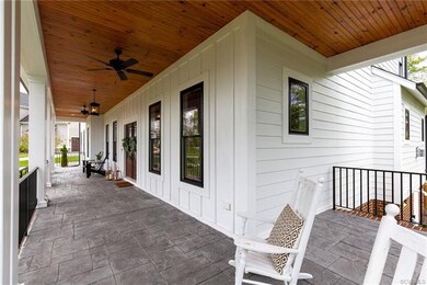 Large wrap around sitting porch with custom stampe