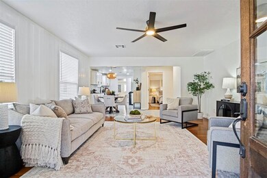 Living room featuring wood finished floors and a ceiling fan