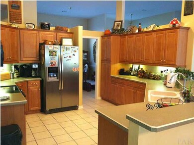 Beautiful kitchen with updated Oak cabinets, tile floor and black appliances