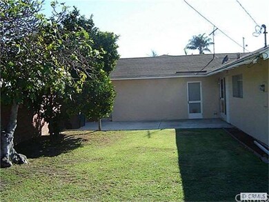 Large backyard with fruit trees.