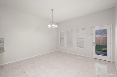 Unfurnished room featuring a chandelier and light tile patterned floors