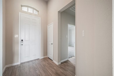 What an entrance! The foyer of the home greets you with beautiful flooring, an office upfront, natural lighting coming from the entry window and so much more!
