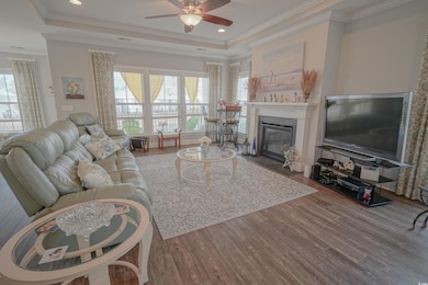 Living room with a fireplace with flush hearth, a 