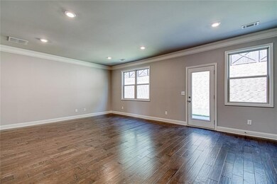 Spare room with visible vents, dark wood-type floo