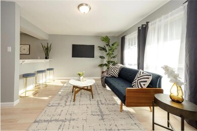 Living area featuring baseboards and wood finishe