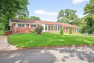 Ranch-style home with brick siding and a front yard