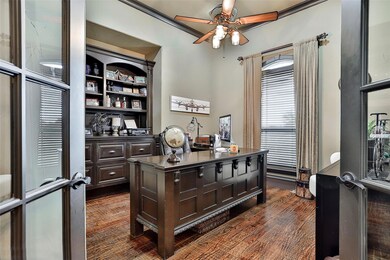 Off the front entryway is this spacious office with built in cabinets and custom made desk. Desk will stay with the home.