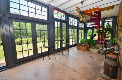 Enclosed Front Porch with KOI Pond, Gas Logs, Stained Glass Window, & Steps to 2nd Level.