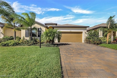 View of front of home with a front yard, stucco si