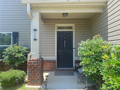 Entrance to property featuring covered porch