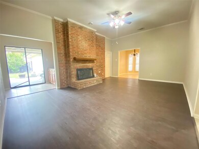 Unfurnished living room with crown molding, hardwo
