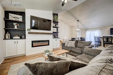 Living room featuring lofted ceiling, a large fire
