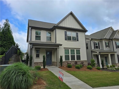Craftsman-style house featuring brick siding, board and batten siding, and a front yard