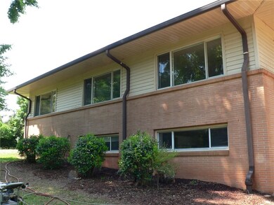 Rear of the home featuring Leaf Guard gutters thro