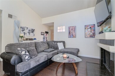 Living room featuring a tiled fireplace, visible v