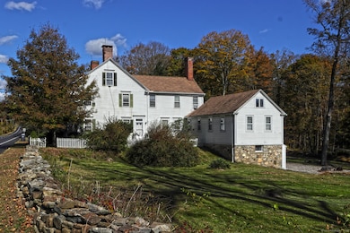 Apt D's windows face south in this view, between the left and right peaked roofs