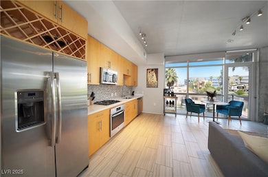 Kitchen with rail lighting, decorative backsplash,