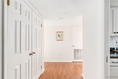 Entry hallway includes a hall closet with custom b