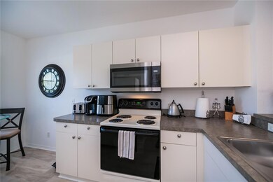 eat-in kitchen breakfast nook with built-in wall pantry closet and breakfast bar