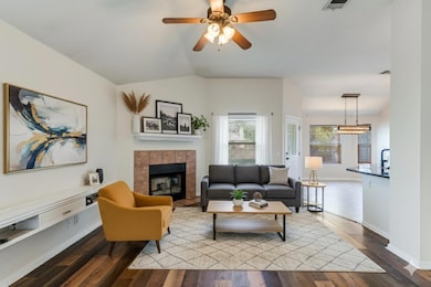Living room featuring wood finished floors, vault